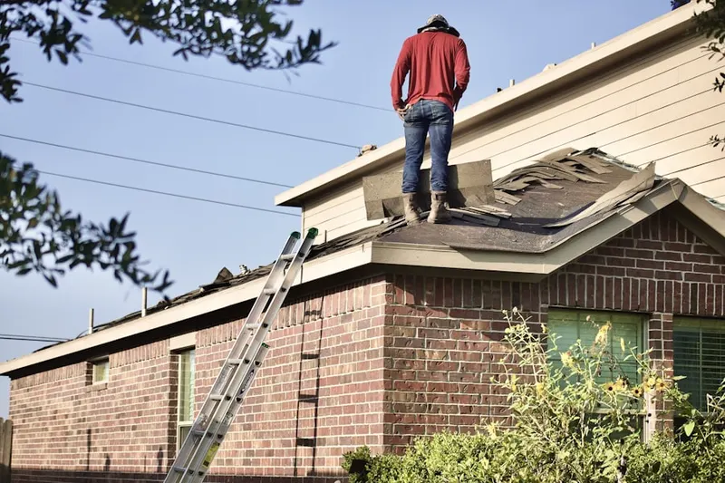 Professional roofer working on a residential roof in New Italy